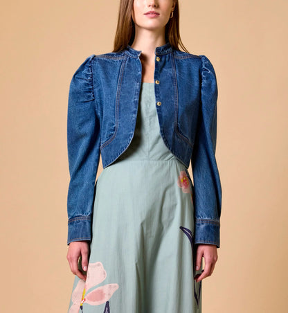 Woman Cleobella | Damien Denim Jacket blue denim jacket over a light green dress on a beige background