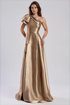 A woman modeling a floor-length satin gown in a warm champagne-gold tone by Daymor One-Shoulder Bow Organza Gown