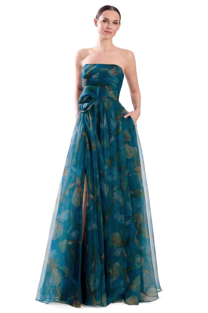 A woman modeling a strapless off-the-shoulder floor-length gown in teal blue-green sheer fabric with a subtle tonal floral pattern. Draped 3D Flower Strapless Gown - Alexander by Daymor 3304F26