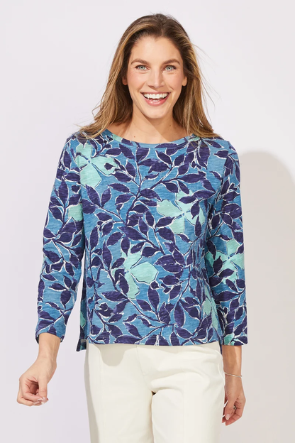 Woman wearing a blue floral patterned top ESCAPE BY HABITAT  FOLIAGE FLORAL COTTON BOXY TEE - 12125 Color Harbor