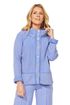 A woman modeling ESCAPE BY HABITAT  MIXED WAFFLE MOCK NECK - 97011 Baja Blue a light blue ribbed knit cardigan with a high stand collar and button-front closure