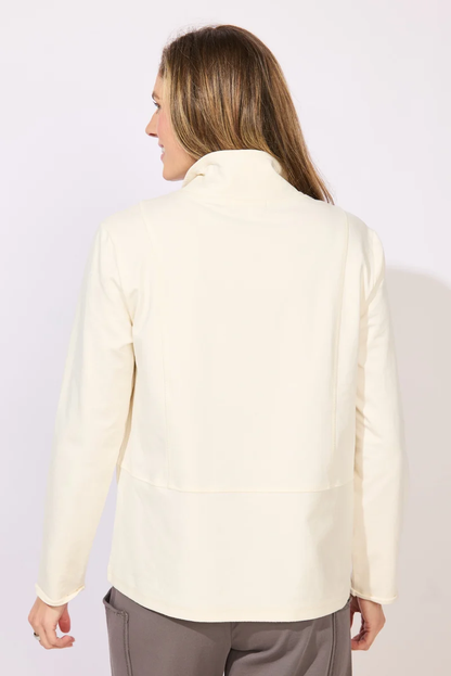 A woman wearing a cream-colored long-sleeve collared top with snap-button details at the collar ESCAPE BY HABITAT  OCEAN FRONT TERRY QUARTER SNAP - 30134 Color Pearl