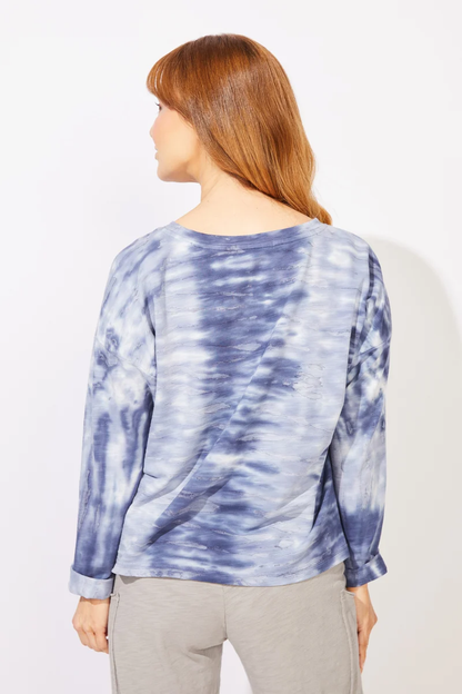 A woman wearing a blue and white tie-dye long-sleeve top    ESCAPE BY HABITAT  RIVER MODAL SPANDEX SUNSET PULLOVER - 45134 navy