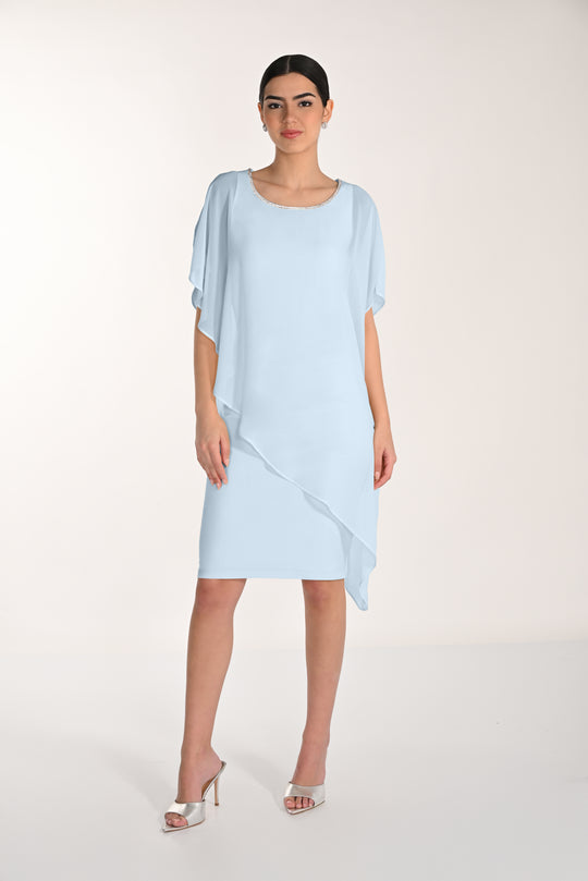Woman wearing a light blue dress on a white background