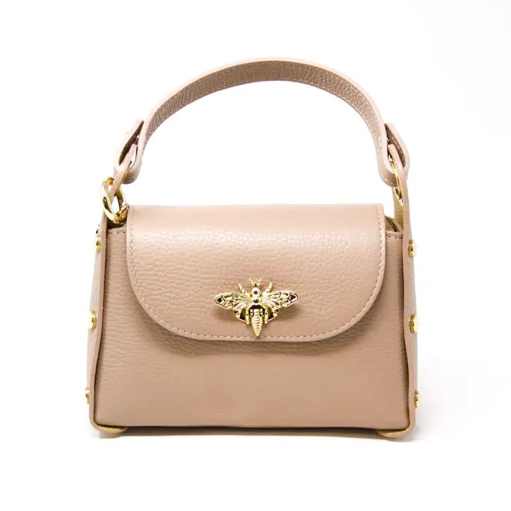 Womens nude/beige handbag with a decorative bee emblem 