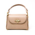 Womens nude/beige handbag with a decorative bee emblem 