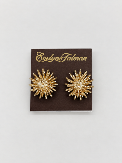 A pair of gold starburst stud clip-on earrings 