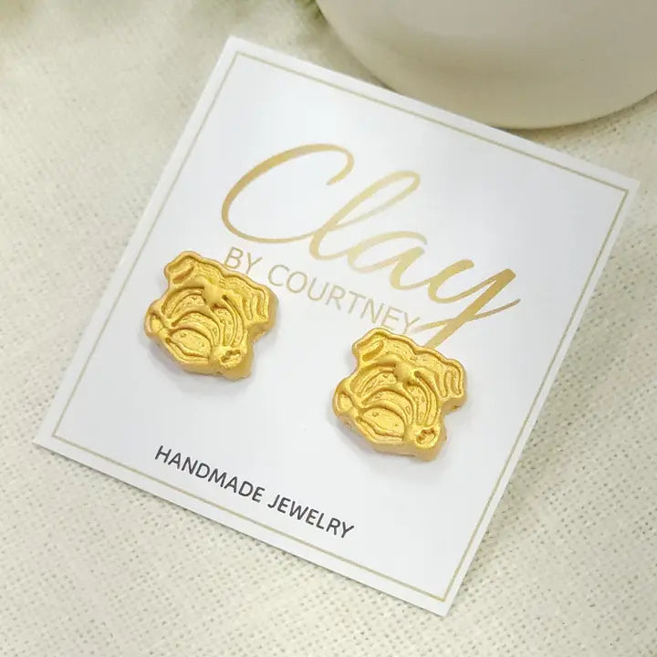 Gold UGA Bulldog Earrings a pair of small gold bulldog face stud earrings displayed on a white backing card that reads &