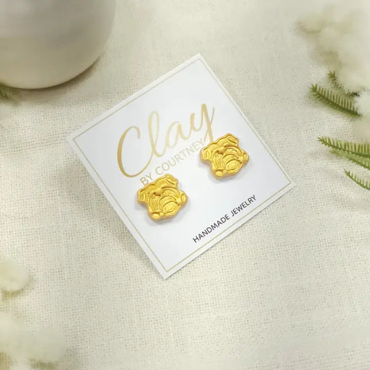 Gold UGA Bulldog Earrings a pair of small gold bulldog face stud earrings displayed on a white backing card that reads &