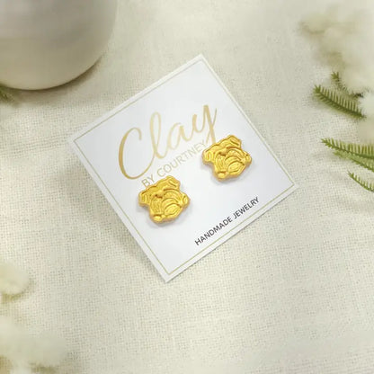 Gold UGA Bulldog Earrings a pair of small gold bulldog face stud earrings displayed on a white backing card that reads &