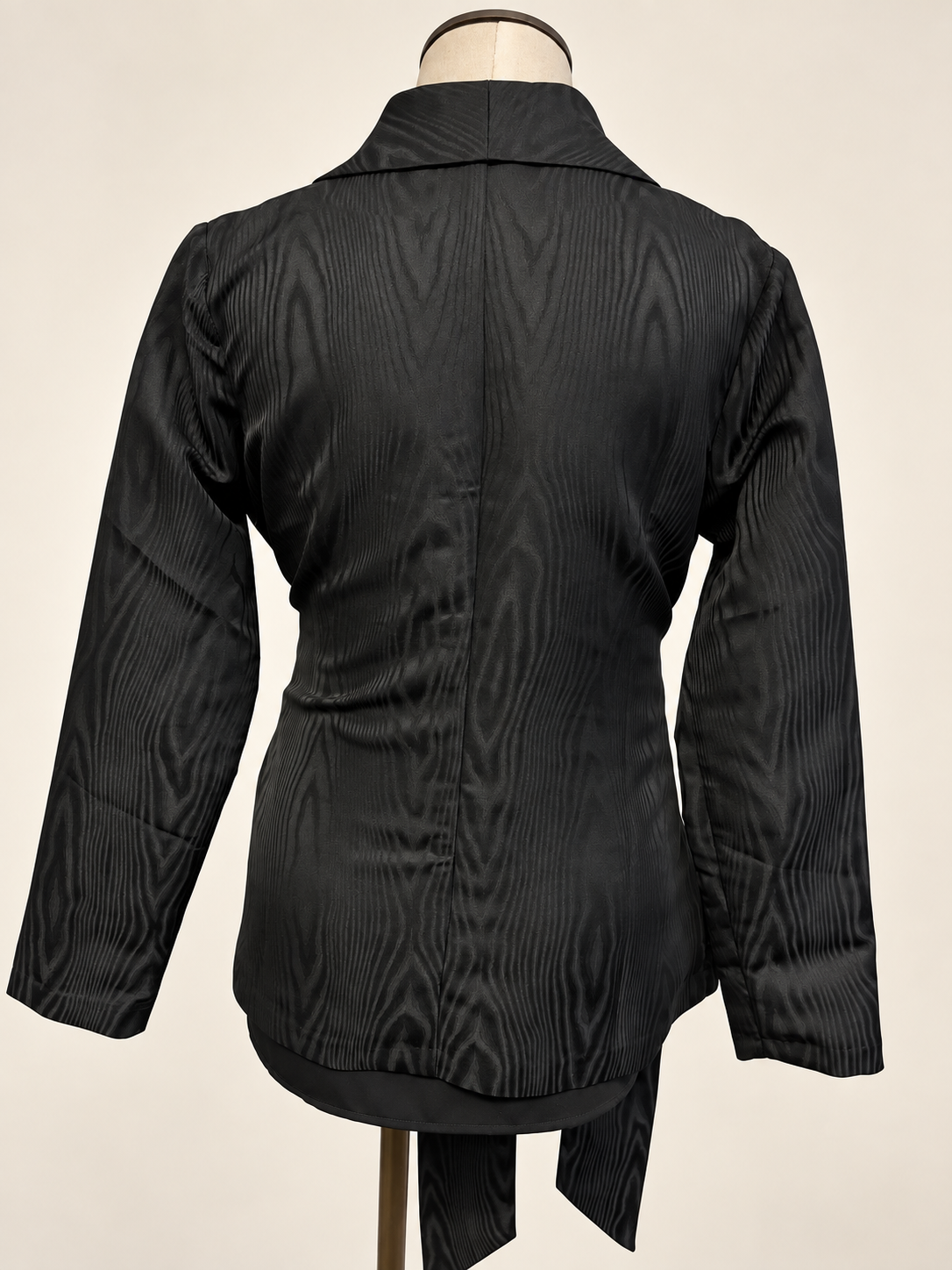 A woman modeling a black satin-like wrap coat J&