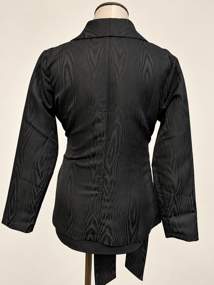 A woman modeling a black satin-like wrap coat J&