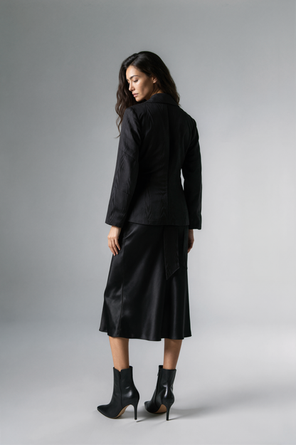 A woman modeling a black satin-like wrap coat J&