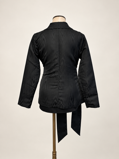 A woman modeling a black satin-like wrap coat J&