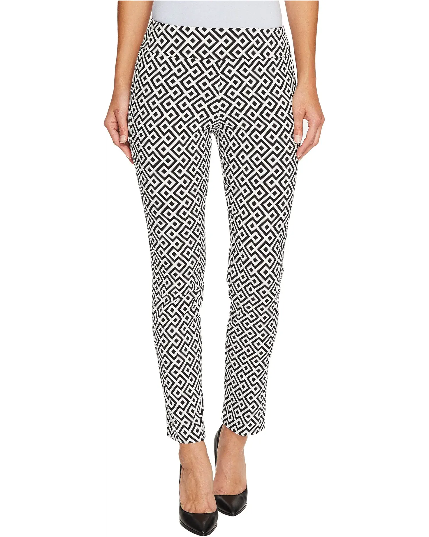 Black and white geometric patterned pants worn by a person on a white background