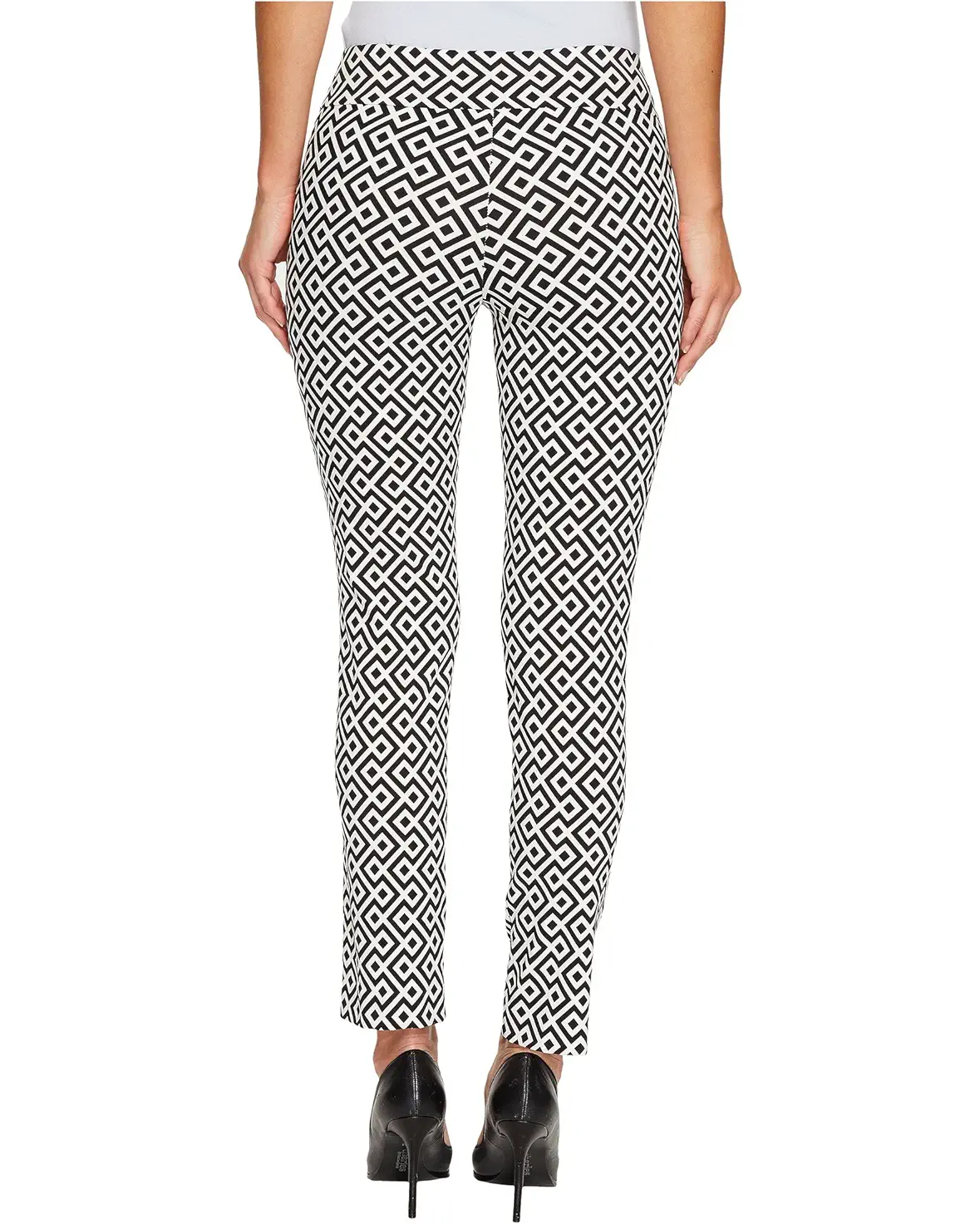 Person wearing black and white geometric patterned pants on a white background
