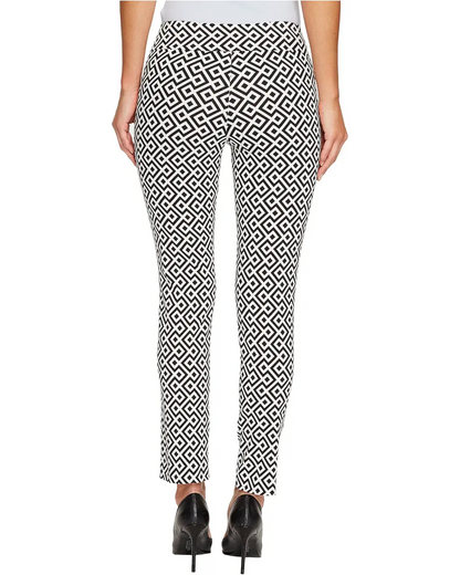 Person wearing black and white geometric patterned pants on a white background