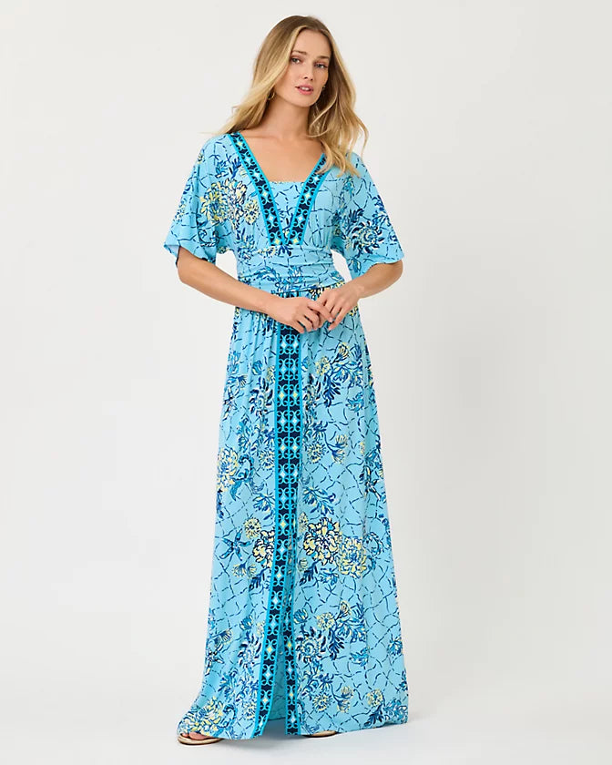 Woman wearing a blue floral dress on a white background