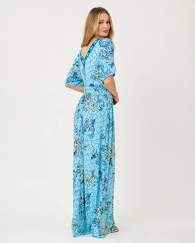 Woman wearing a blue floral dress on a white background