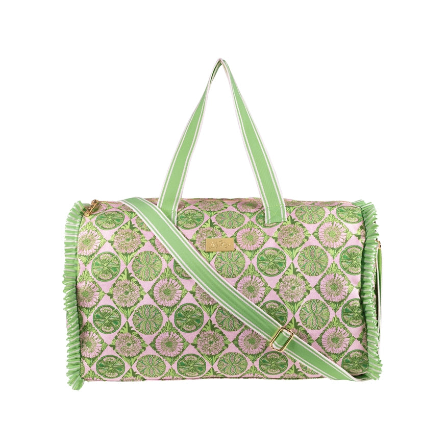 A Lilly Pulitzer Duffle Tote, Tropical Tiles tote bag with a green and pink citrus slice pattern, featuring pale green handles and a small gold-tone Lilly Pulitzer logo plaque. 