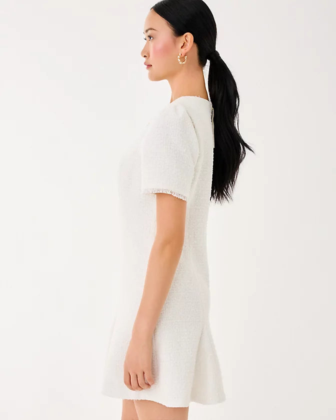 Woman wearing a white dress with a plain background