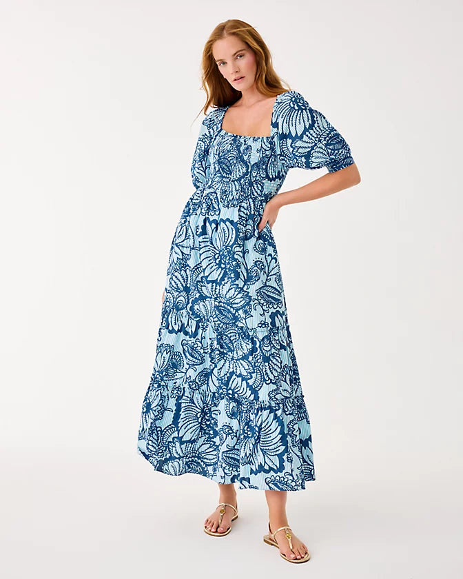 Woman wearing a blue floral dress on a white background