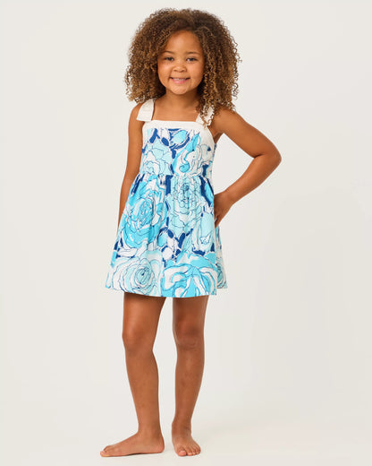 Young girl wearing a blue floral dress on a white background