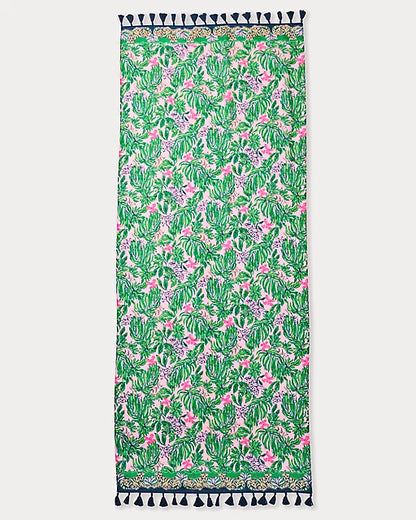 Towel with tropical leaf pattern and tassels on a white background