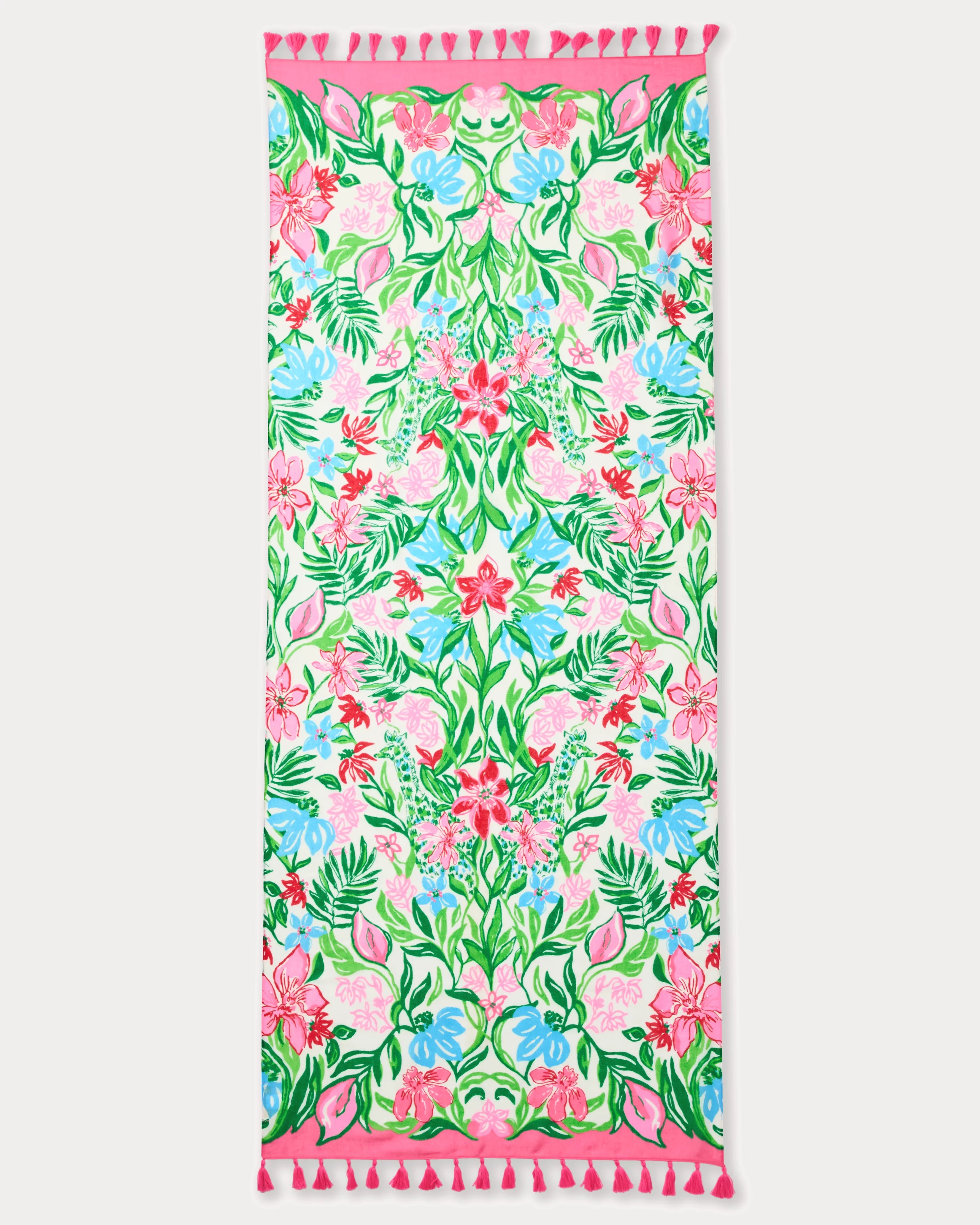 Floral patterned towel with pink border and tassels on a white background