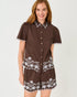 Lilly Pulitzer Rikki Short Sleeve Embroidered Top in Coco beach marni embroidered poplin brown short-sleeve button-front romper with white floral embroidery and scalloped trim.