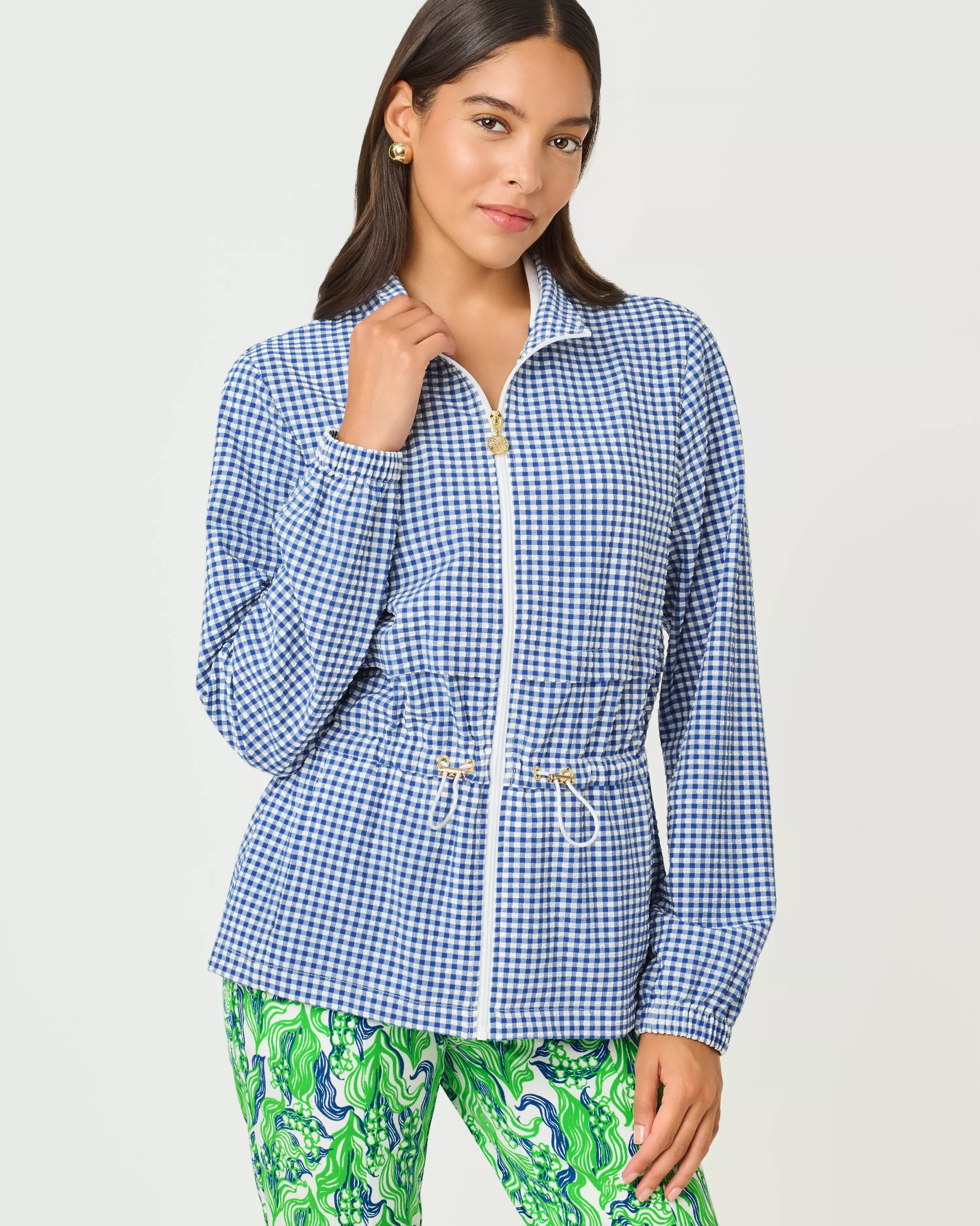 Woman wearing a blue checkered jacket with a white background