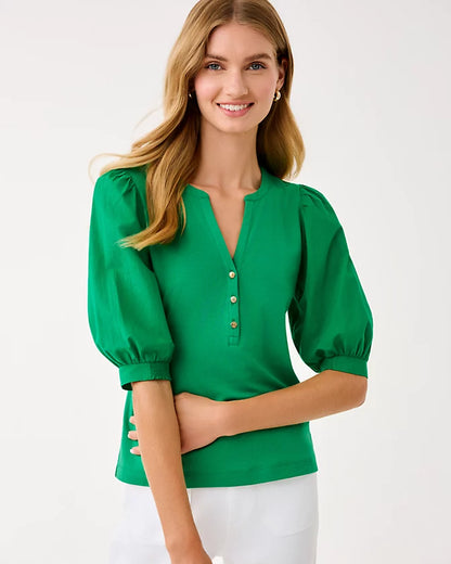 Woman wearing a green blouse with puff sleeves on a white background