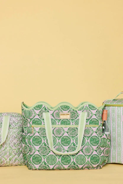 Lilly Pulitzer Scallop Cooler Tote, Tropical Tiles a cooler tote bag with a green and pink floral pattern, featuring light green handles and a matching shoulder strap with white stripes