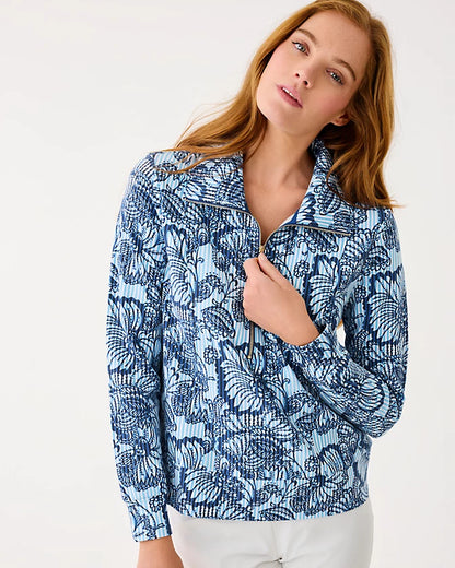 Woman wearing a blue floral patterned jacket on a white background