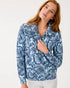 Woman wearing a blue floral patterned jacket on a white background