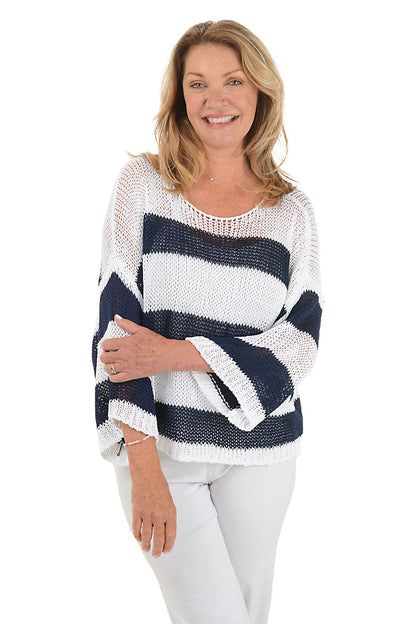 Woman wearing a navy and white striped sweater on a white background