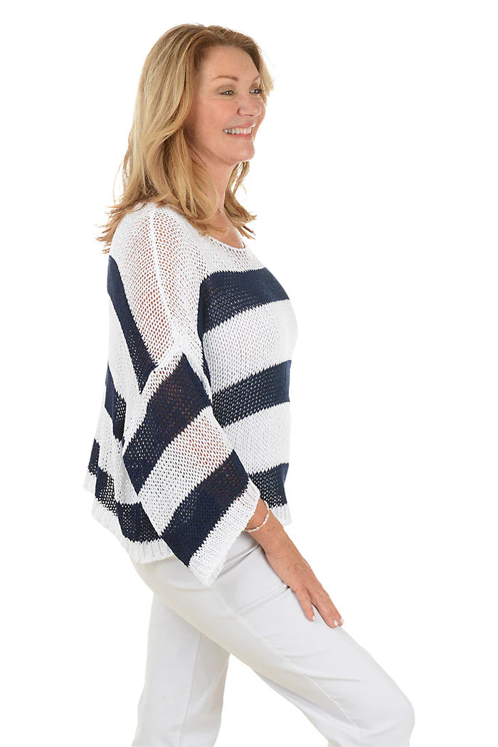 Woman wearing a navy and white striped sweater on a white background