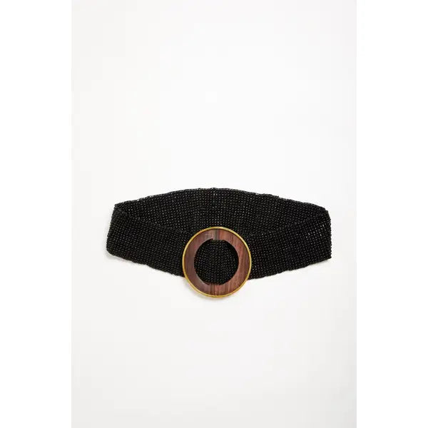 A black beaded belt with a large circular wooden inlay and a gold-tone metal rim by Mare Sole Amore Black Lunar Slip on Stretch BelT