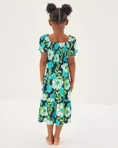 Young girl wearing a floral dress on a white background