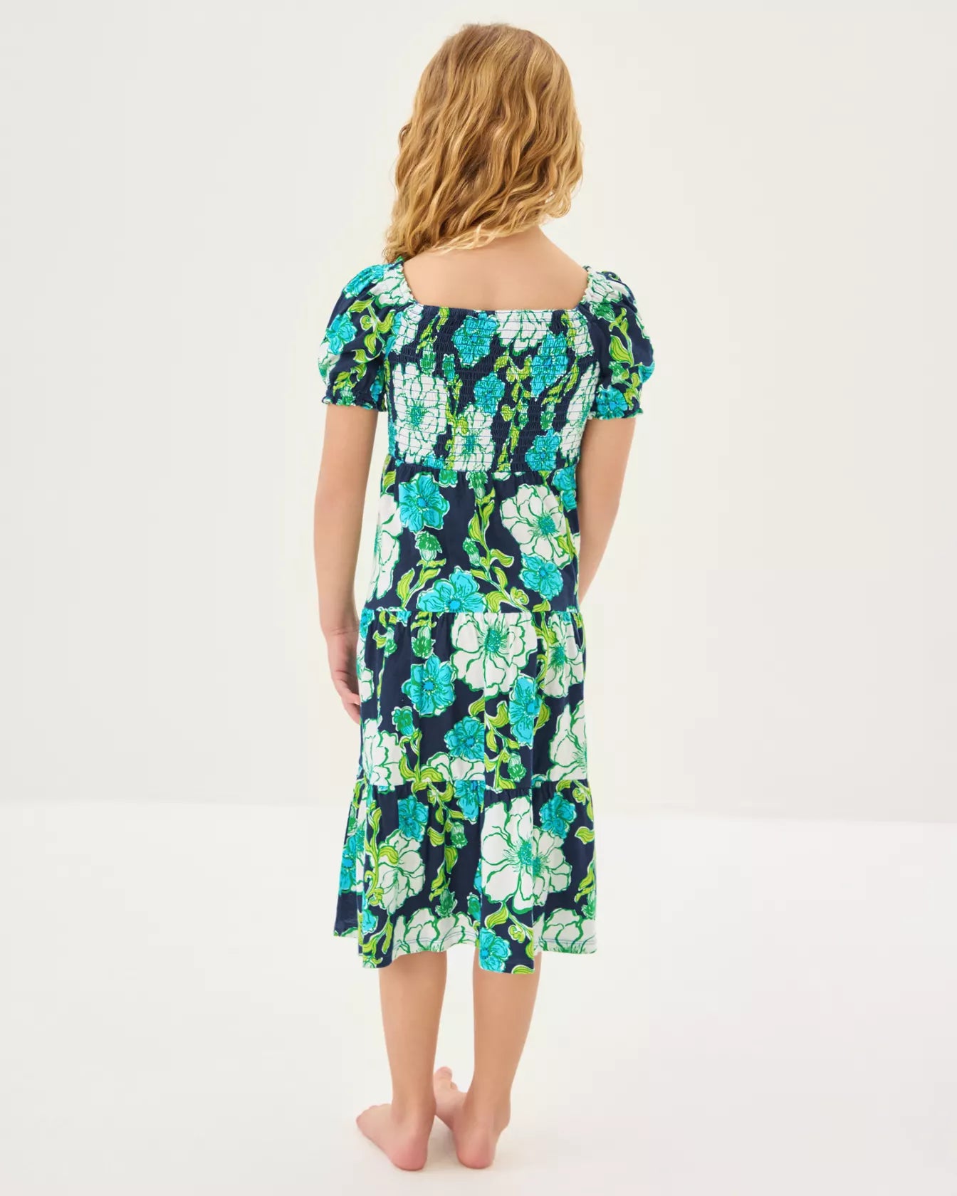 Woman wearing a floral dress on a white background