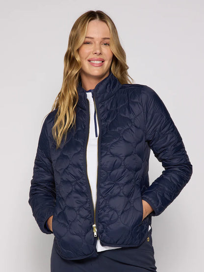 Woman wearing a navy quilted jacket on a white background