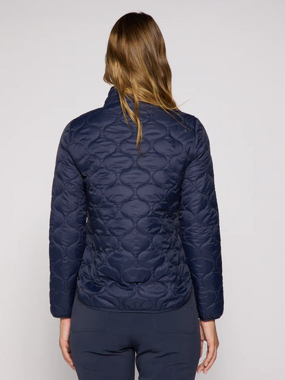 Person wearing a navy quilted jacket on a plain background