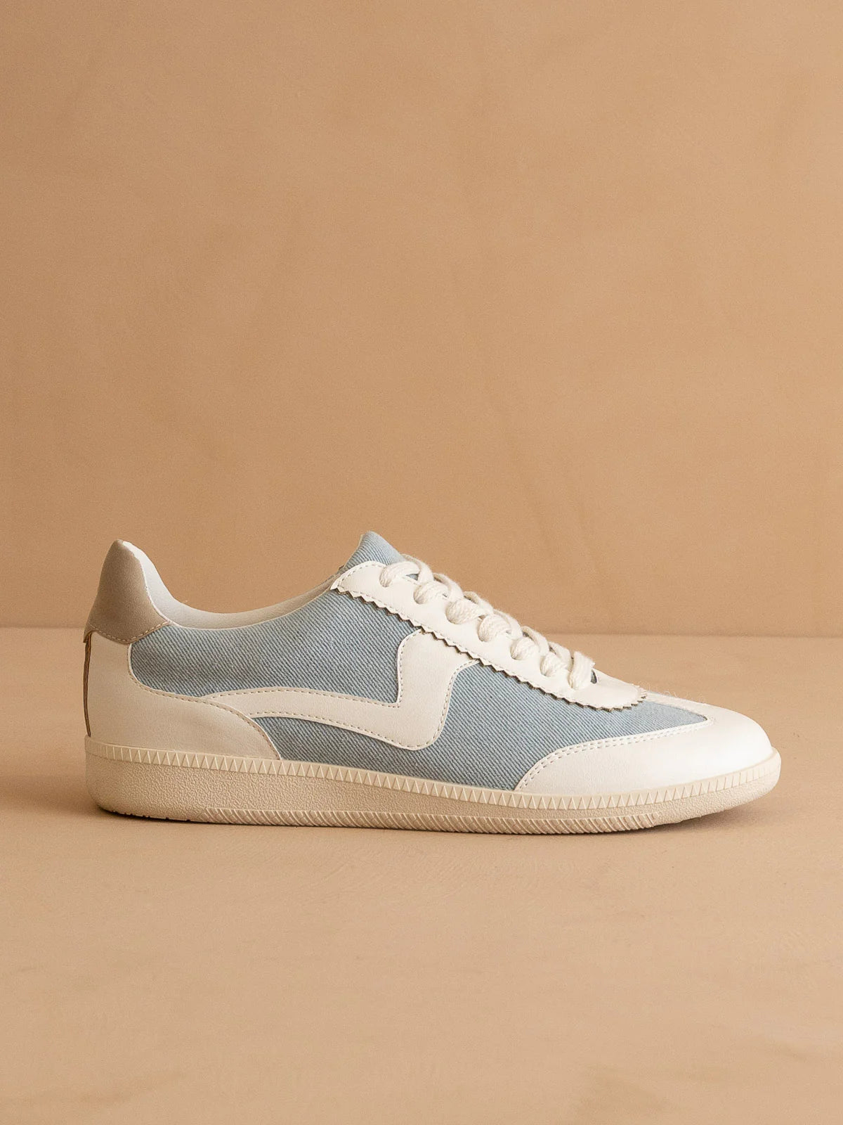 Blue and white sneaker on a beige background