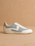 Blue and white sneaker on a beige background