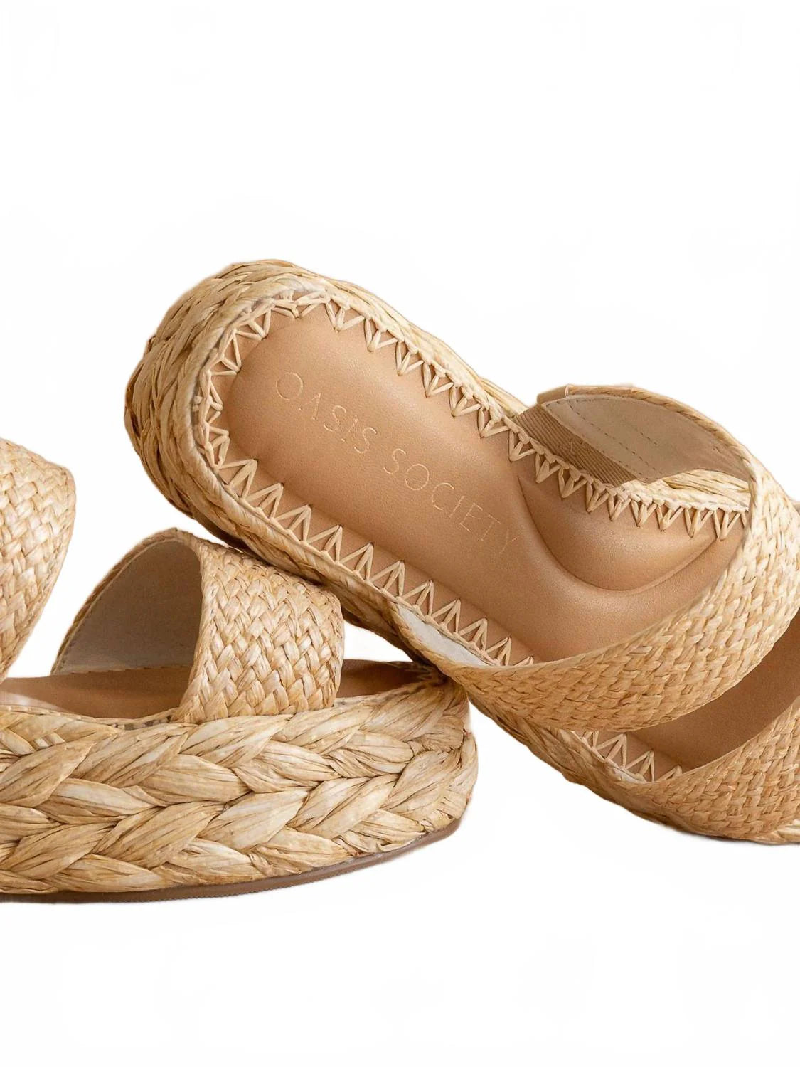 Pair of woven sandals on a white background