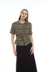 A woman modeling a short-sleeve tweed jacket with a button-up front and a matching tie waist