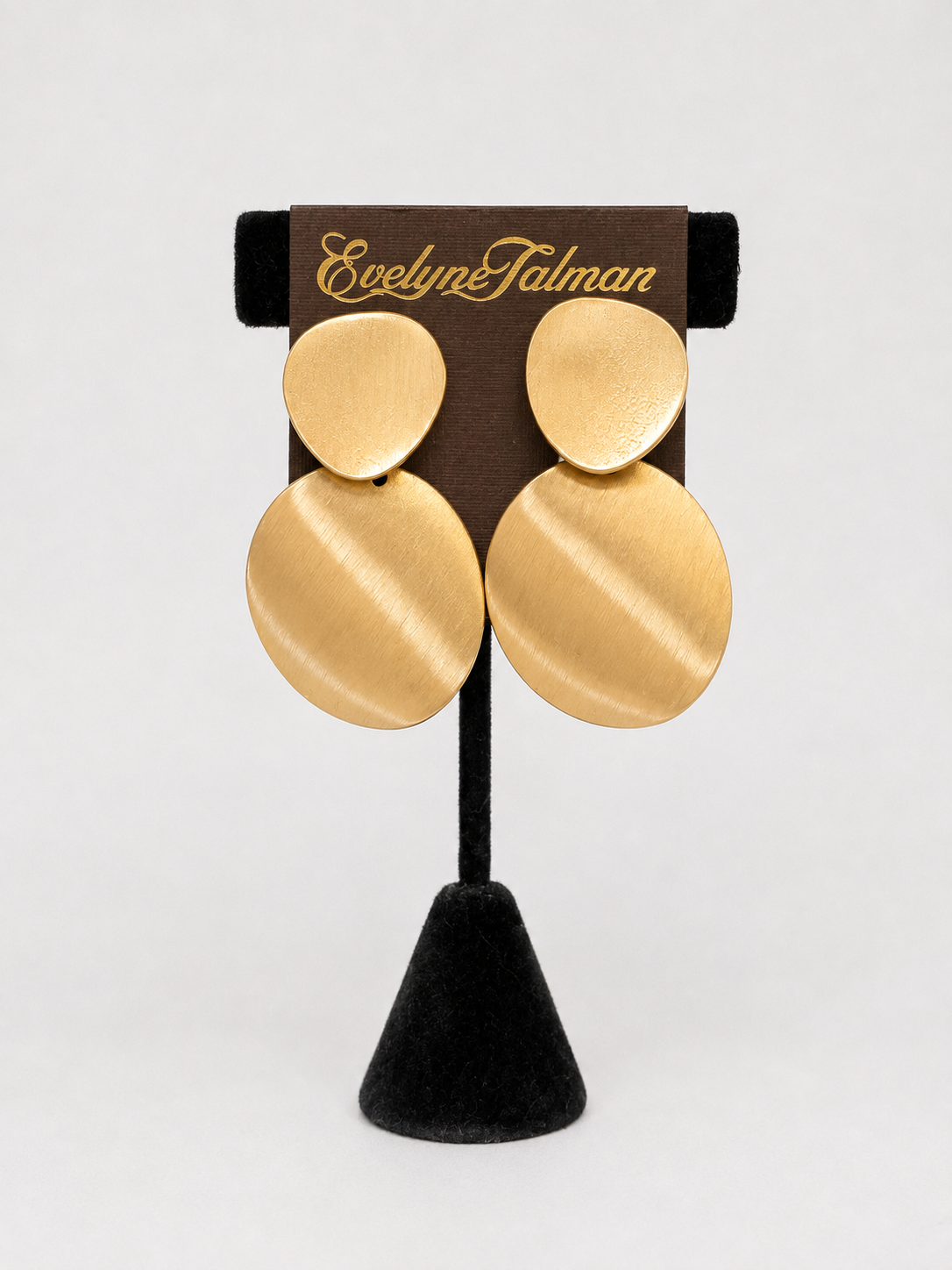 A pair of large, disc-shaped gold earrings Semi Matte Oval Gold Clip Earring