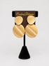 A pair of large, disc-shaped gold earrings Semi Matte Oval Gold Clip Earring