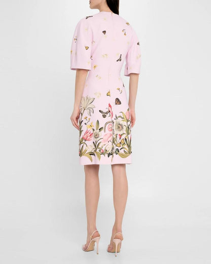 Pink dress with floral and butterfly pattern on a white background