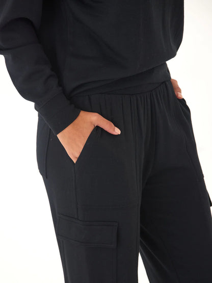 Person wearing black pants with a white background